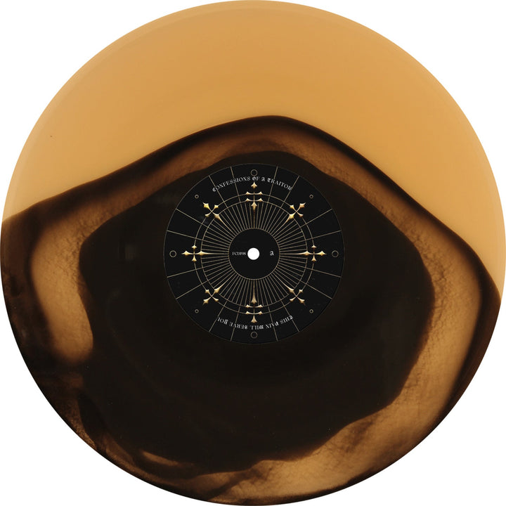 Confessions Of A Traitor releases a limited edition Golden Eclipse vinyl on May 16, 2025, featuring a unique marbled tan and dark brown design with a black center label adorned with geometric lines and small symbols.