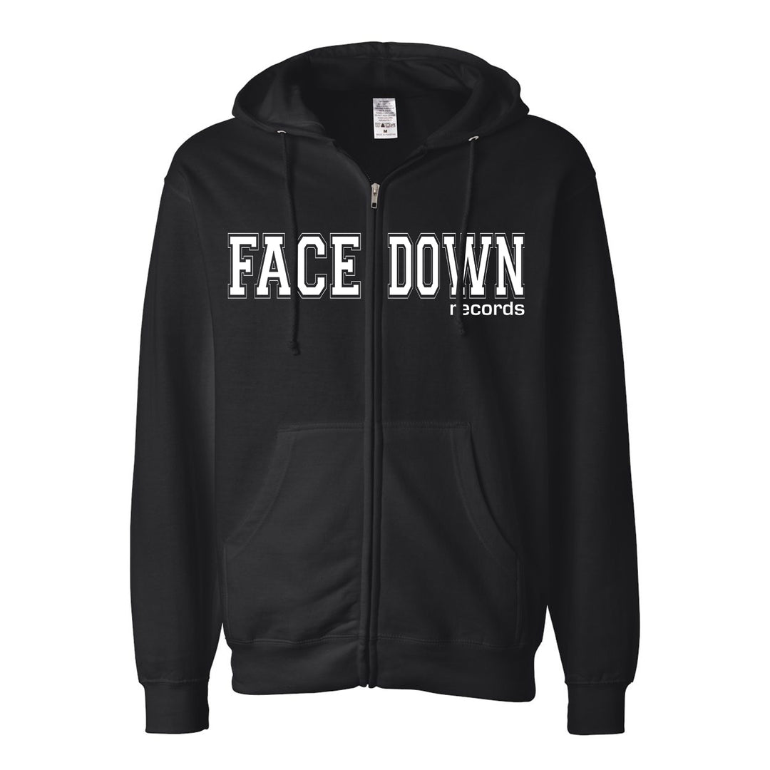 A black Facedown Records zip-up hoodie with a drawstring hood, featuring FACEDOWN RECORDS in bold white letters across the chest.