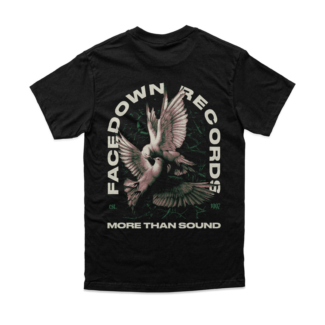 Facedown Records black Comfort Colors tee features two doves in flight at the center, bold FACEDOWN RECORDS text in an arc, MORE THAN SOUND below, and est. 1997 in smaller print.