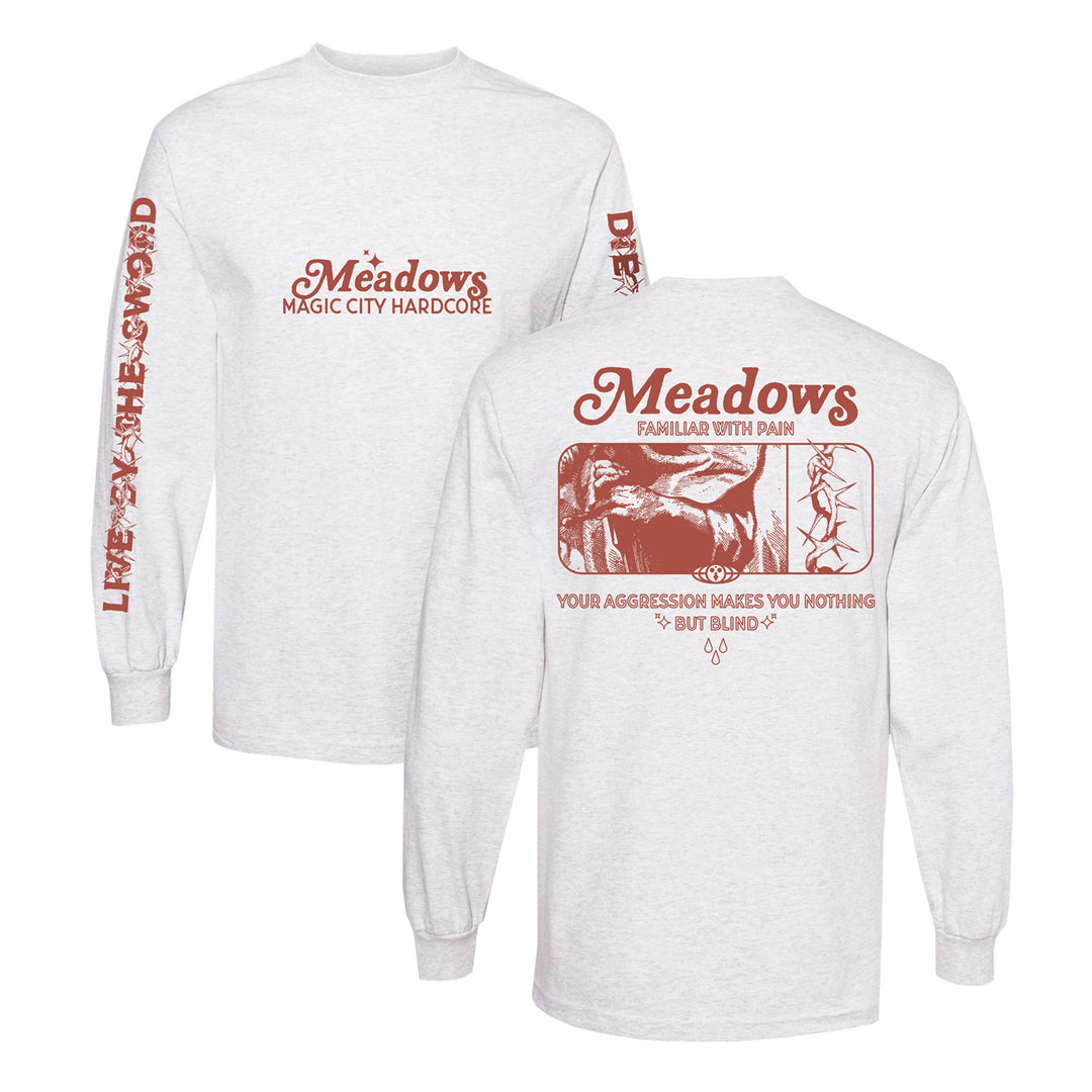 Two classic fit white long-sleeve shirts made from Gildan Heavy Cotton, featuring red graphics and text: Meadows Magic City Hardcore on the front, Live By Aggression Die By Aggression on the sleeve, and a large back graphic with Meadows Familiar with Pain and Your aggression makes you nothing but blind.