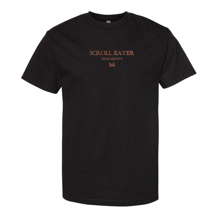 Black t-shirt crafted from 100% cotton with the words SCROLL EATER, SINCE MMXVI, and a small graphic printed in orange on the front center. Inspired by classic heavyweight t-shirts like the American Apparel 1301 for a comfortable and lasting fit.