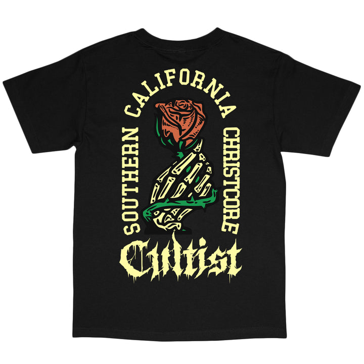 Black t-shirt made from 100% cotton with a colorful rose and hand graphic on the back. Text around the design reads Southern California Chr1stcore Cultist in bold, stylized fonts. This American Apparel tee offers a relaxed fit for ultimate comfort and style.