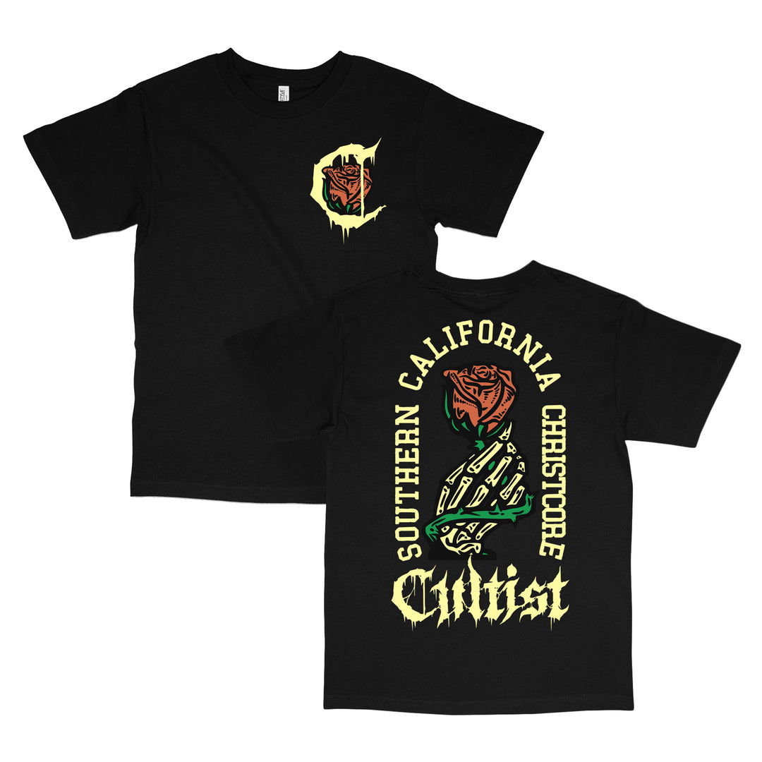 Black t-shirt crafted from 100% cotton in a relaxed fit, featuring bold yellow Cultist text, a striking red rose with green leaves, and Southern California Christcore lettering on the back. The front highlights a small rose and C design on the left chest. Made with premium American Apparel quality for ultimate comfort and style.