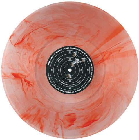 A translucent orange and clear limited edition vinyl record with red swirls, featuring a black label in the center designed like a shooting target with numbers and bullet holes—perfect for collectors eagerly anticipating the album pre-order of Desert Walker Seeing Red.