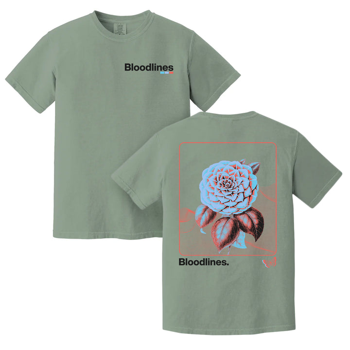 Sage green t-shirt crafted from soft, ring-spun cotton for exceptional comfort. Features Bloodlines. on the front and a large, detailed flower with Bloodlines. below it on the back, outlined in red and blue. This garment-dyed Comfort Colors T-Shirt offers both style and durability.
