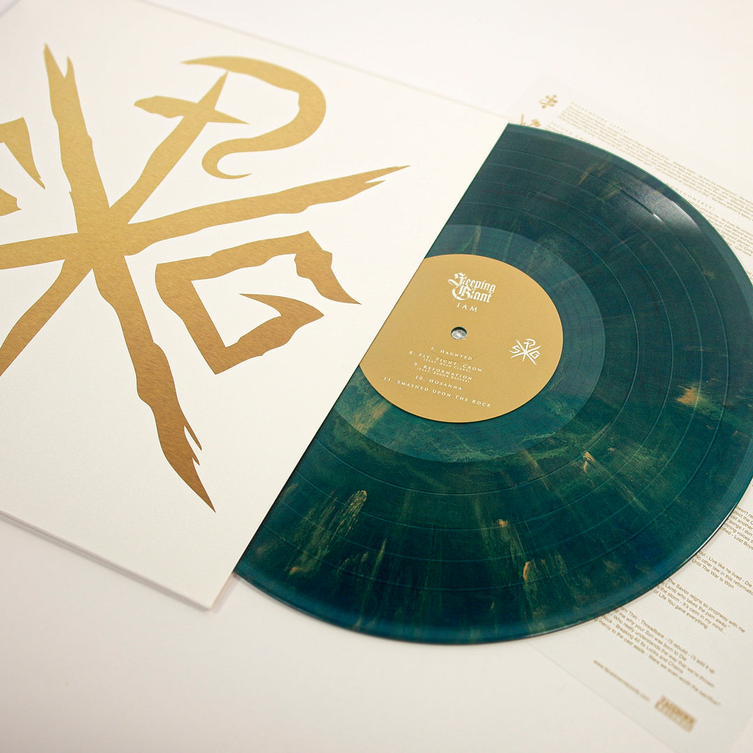 A translucent green vinyl with golden streaks slides from its white sleeve, which displays a bold gold abstract symbol. The center label features "Sleeping Giant," "Preachcore Lives," and "Second Chance Kids" in gold text.