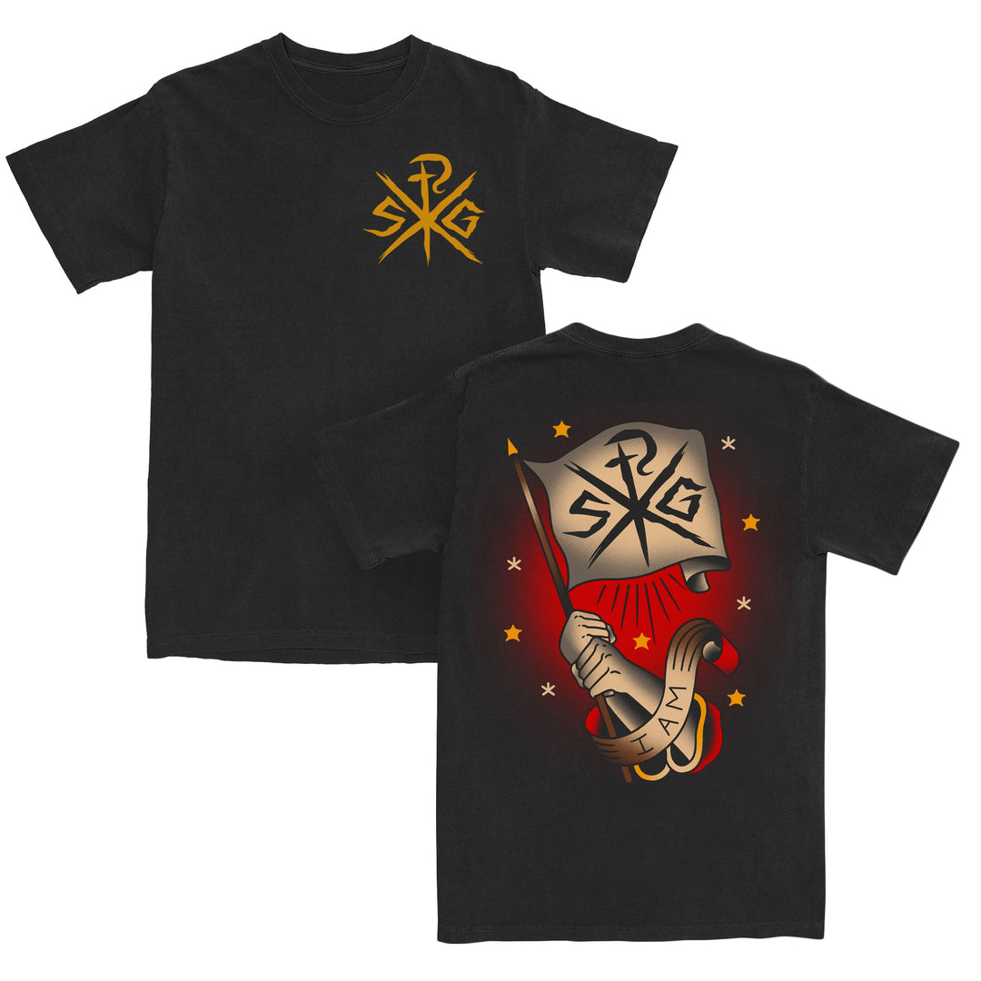 Black American Apparel T-shirt with a gold SRG logo on the front. The back features a hand holding a flag with the same logo, surrounded by stars, a red glow, and a scroll reading I AM. Crafted from 100% cotton in a relaxed fit for comfort and style.