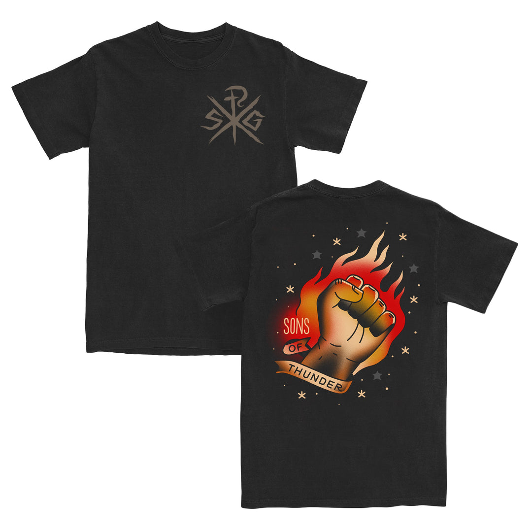 Black t-shirt with subtle front logo. Crafted from soft ring-spun cotton by ComfortWash By Hanes, it ensures all-day comfort. The back features a flaming raised fist, stars, and a banner reading Sons of Thunder in bold letters, with striking artwork by Dave Quiggle.