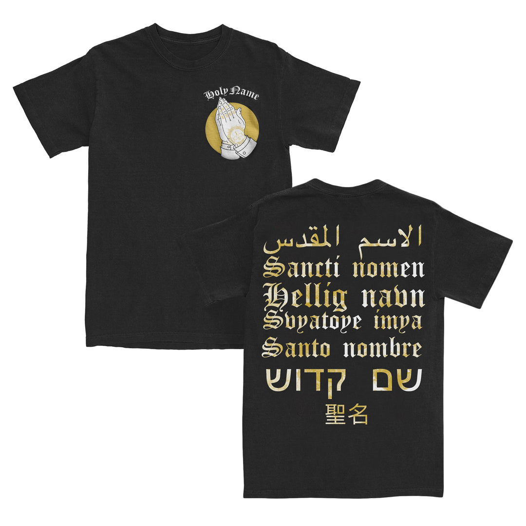 Black T-shirt crafted from high-quality ring-spun cotton, featuring praying hands and Holy Name text on the front. The modern classic fit provides comfort and style, while the back showcases Holy Name in multiple languages—including Arabic, Latin, German, Spanish, Hebrew, Chinese, and Cyrillic—in gold and white script. Part of our Gildan Softstyle T-Shirts collection.