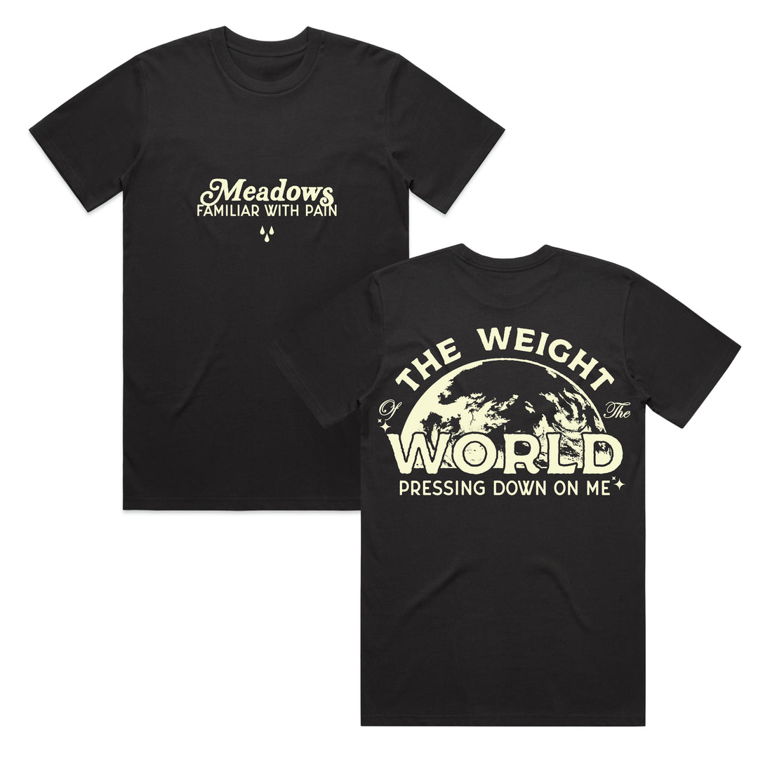 Black t-shirt crafted from 100% cotton, featuring front text: Meadows Familiar With Pain. This classic fit t-shirt is made with Gildan Ultra Cotton for comfort and durability. The back showcases large text: The Weight of the World Pressing Down On Me, paired with an illustration of the Earth beneath the words.