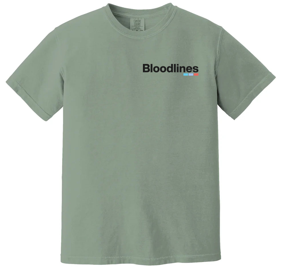 A Bloodlines Comfort Colors sage green short-sleeve t-shirt featuring “Bloodlines” in black on the left chest, highlighted by small red and blue lines under the last letters—ideal for everyday wear.