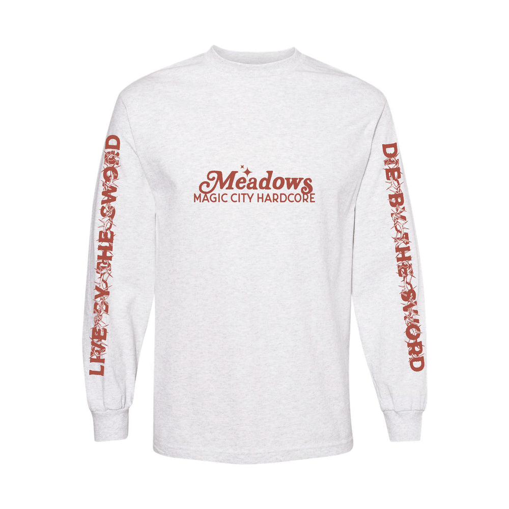 The Meadows heavy cotton long sleeve shirt features “Meadows Magic City Hardcore” in red on the chest, red sleeve text—left: “LIVE BY THE SWORD,” right: “DIE BY THE SWORD”—and a rib collar for comfort. Classic fit.