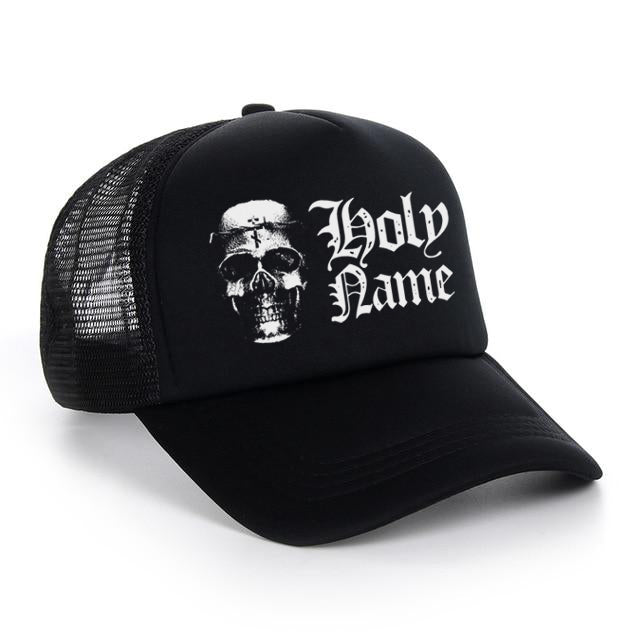 The HolyName black mesh trucker cap features a bold, gothic-style white skull graphic and the words Holy Name on the front panel.